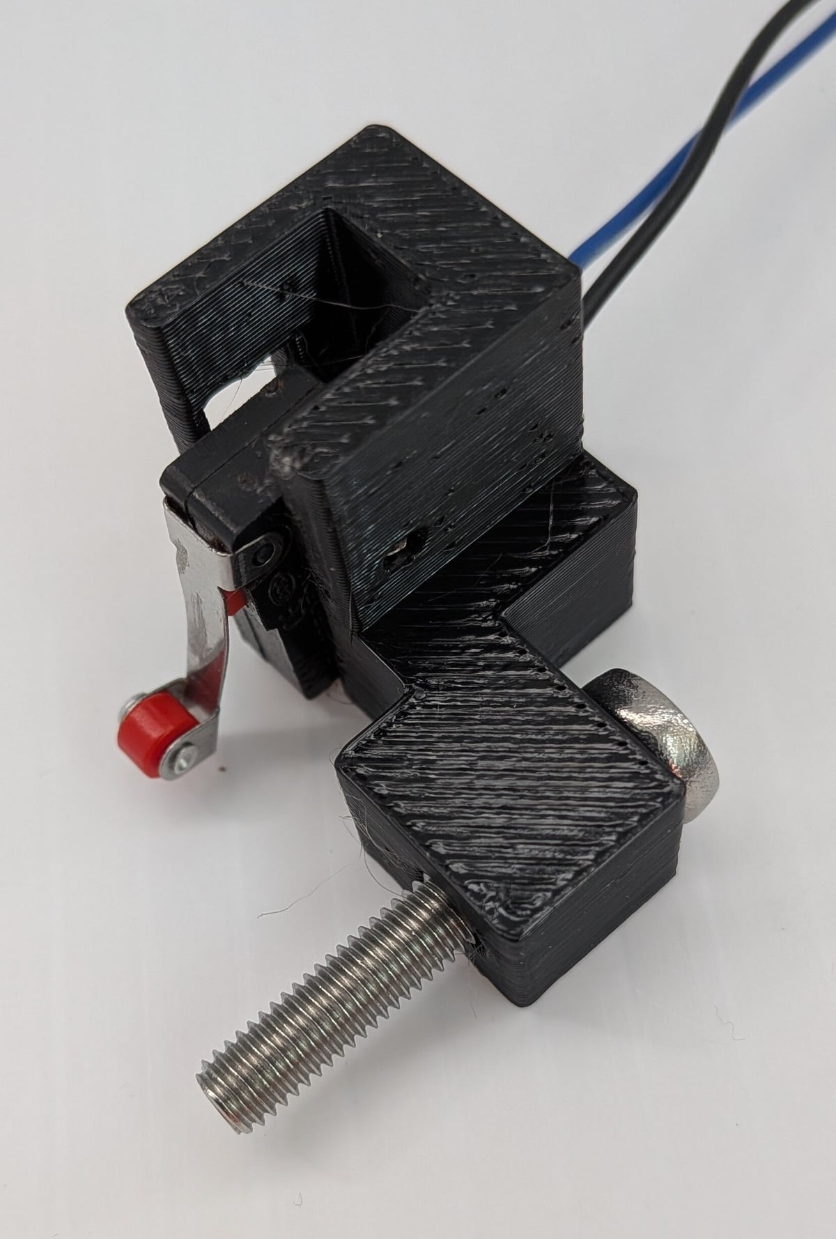 Roll cutter carriage home sensor with roller switch and adjustable mounting hardware