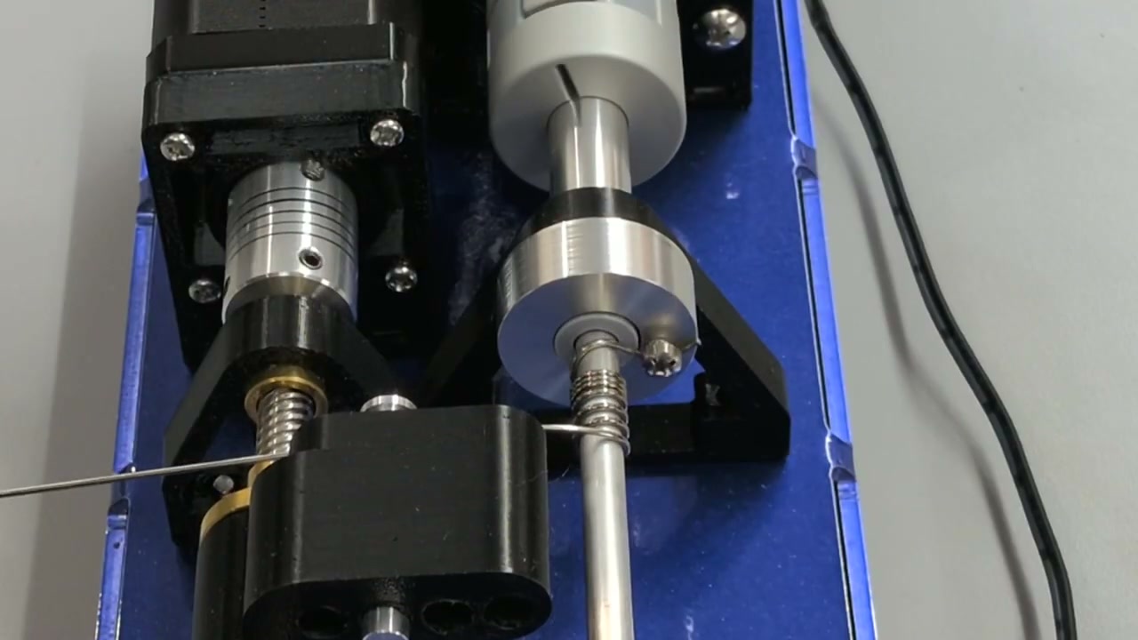 Close-up of wire feeding onto the mandrel during spring forming